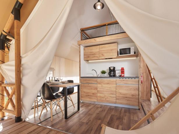 Modern wooden kitchen inside a glamping tent.